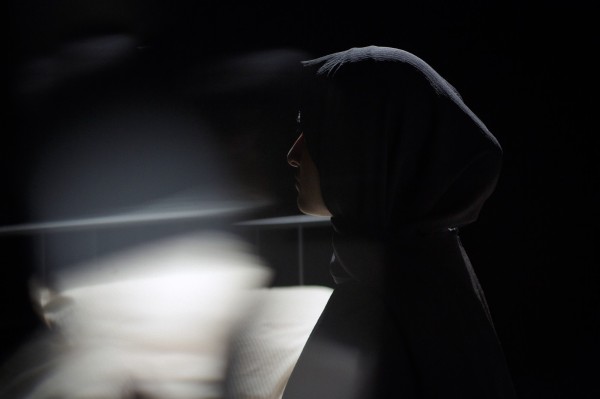 A still from a film by Lipa Hussain titled Roll Down the Window which is a black and white shot of a woman in a headscarf 